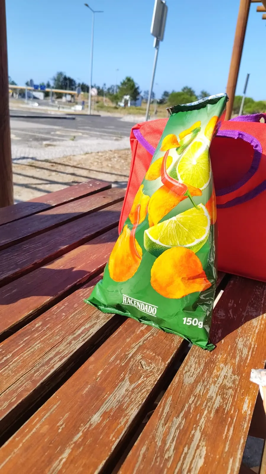 A bag of chili-lime chips on a picnic table on the road with Sadhäna